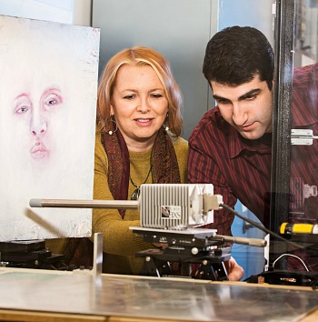 Fiona McNeill works with Eric Johnson on an x-ray focussing device designed to analyze elements in the paint used in Van Gogh’s 'Ginger Jar with Onions.’ This technique revealed a painting under the visible painting. 
