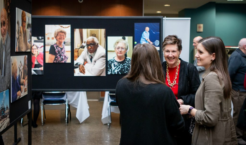 McMaster Chancellor Suzanne Labarge and Seniors of Canada creators Stephanie Hatzifilalithis, left, and Rachel Weldrick talk about their photo exhibition at MIRA. 