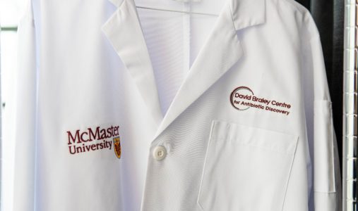 Close-up of a lab coat that reads "David Braley Centre for Antibiotic Discovery." 