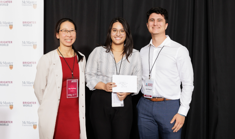 Gay Yuyitung, executive director of MILO, presents the Commercial Potential award to Paige Chandran Blair and Justin Alvarado.