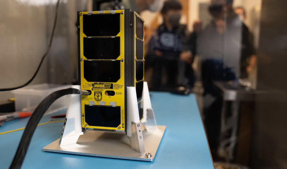 McMaster's NEUDOSE Satellite sits on a table during a lab tour.