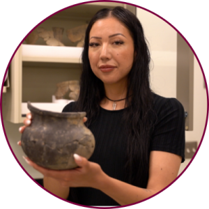 A person holding an unearthed cooking vessel 