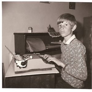 Image of Daniel Coleman as a child with a typewriter