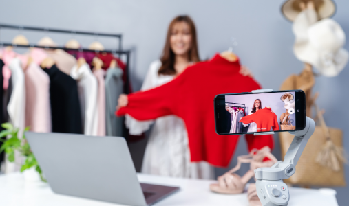 An influencer holds up clothing during a livestream 