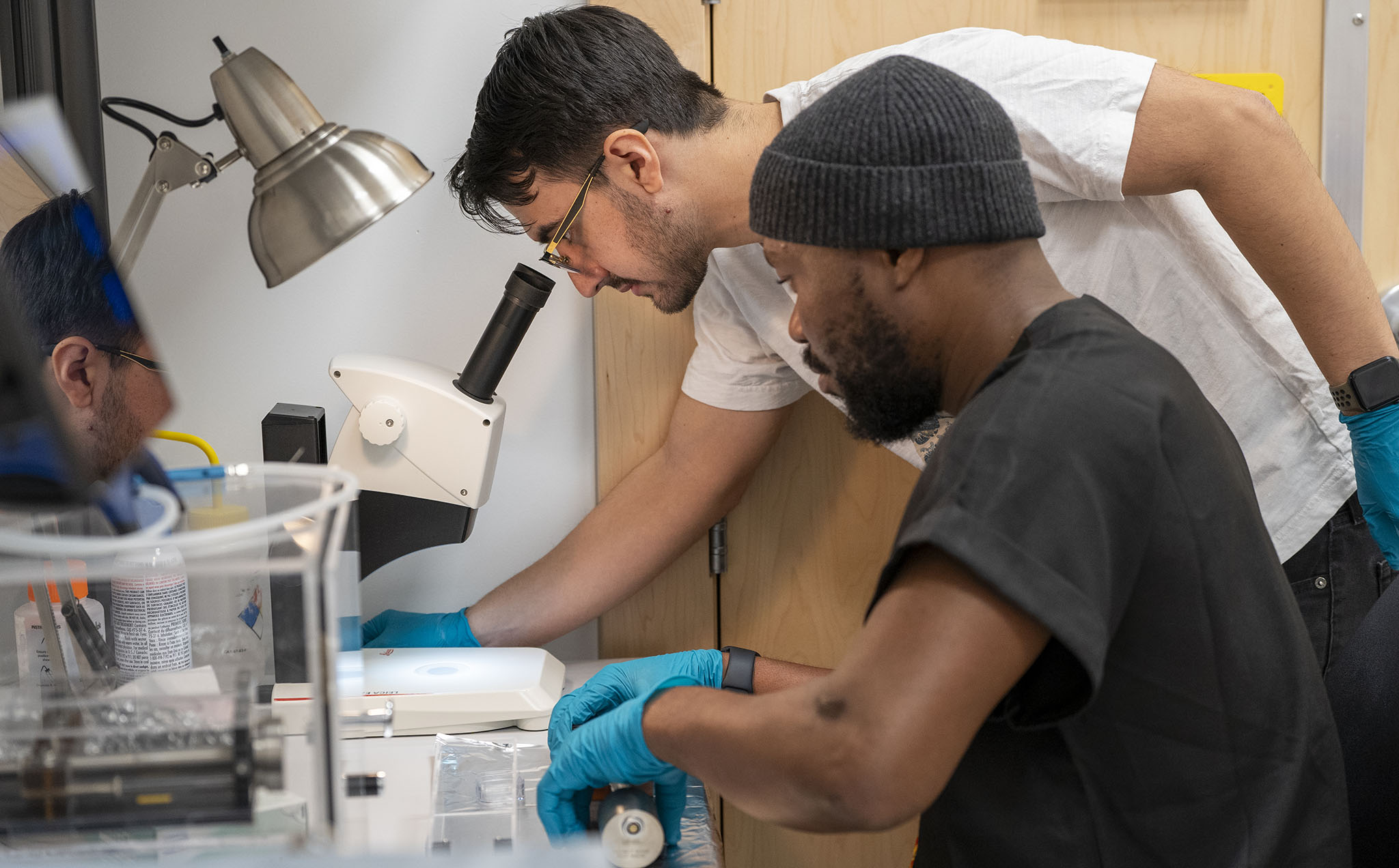 PhD students Babafemi Agboola (front) and Joaquin Eduardo Reyes Gonzalez prepping materials for the Nion HERMES 100 electron microscope.