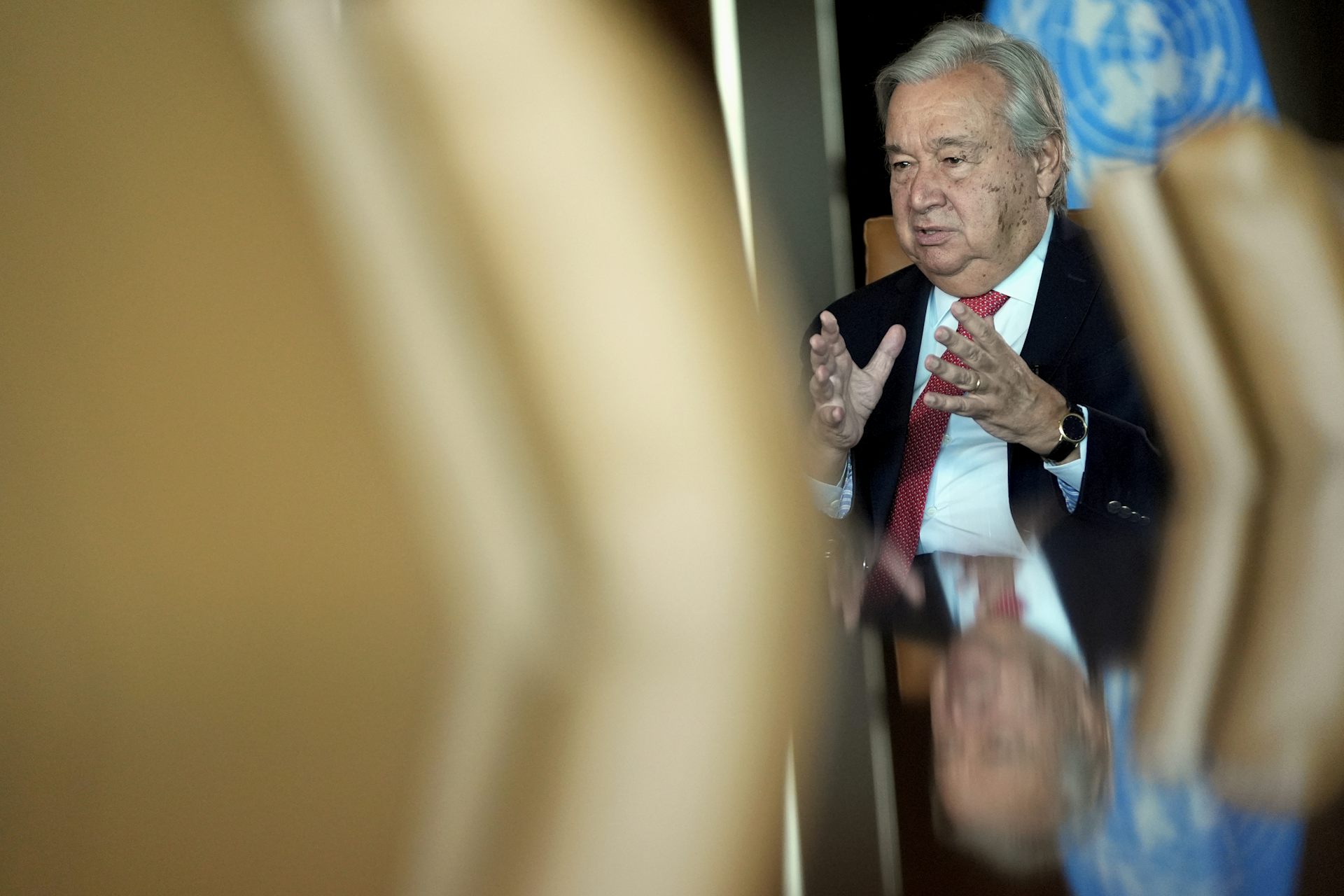 Antonio Guterres gesturing with his hands in conversation.