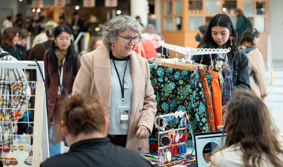 A shopper browses the Indigenous marketplace in MUSC.