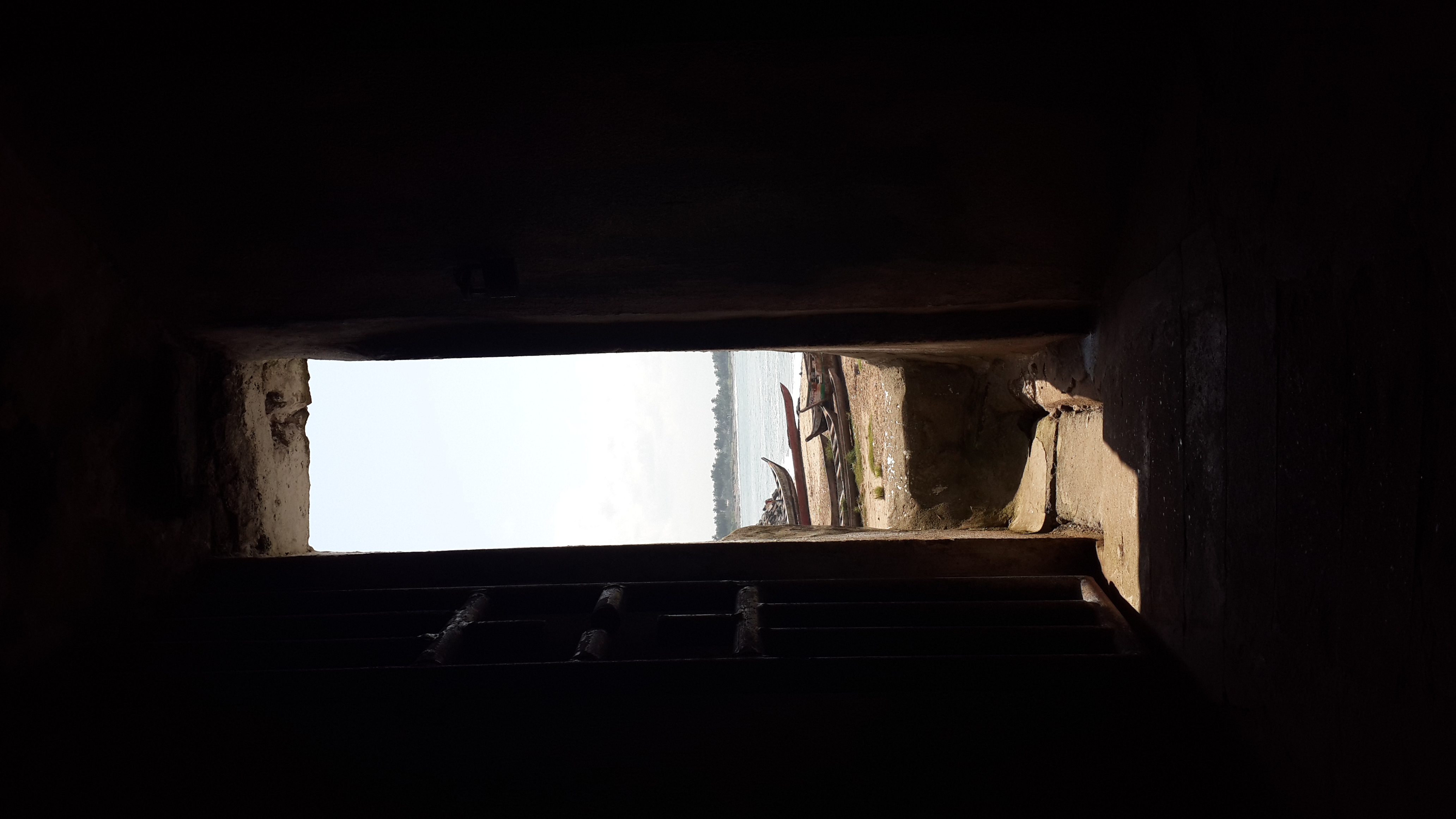 Through a window, a body of water is visible.