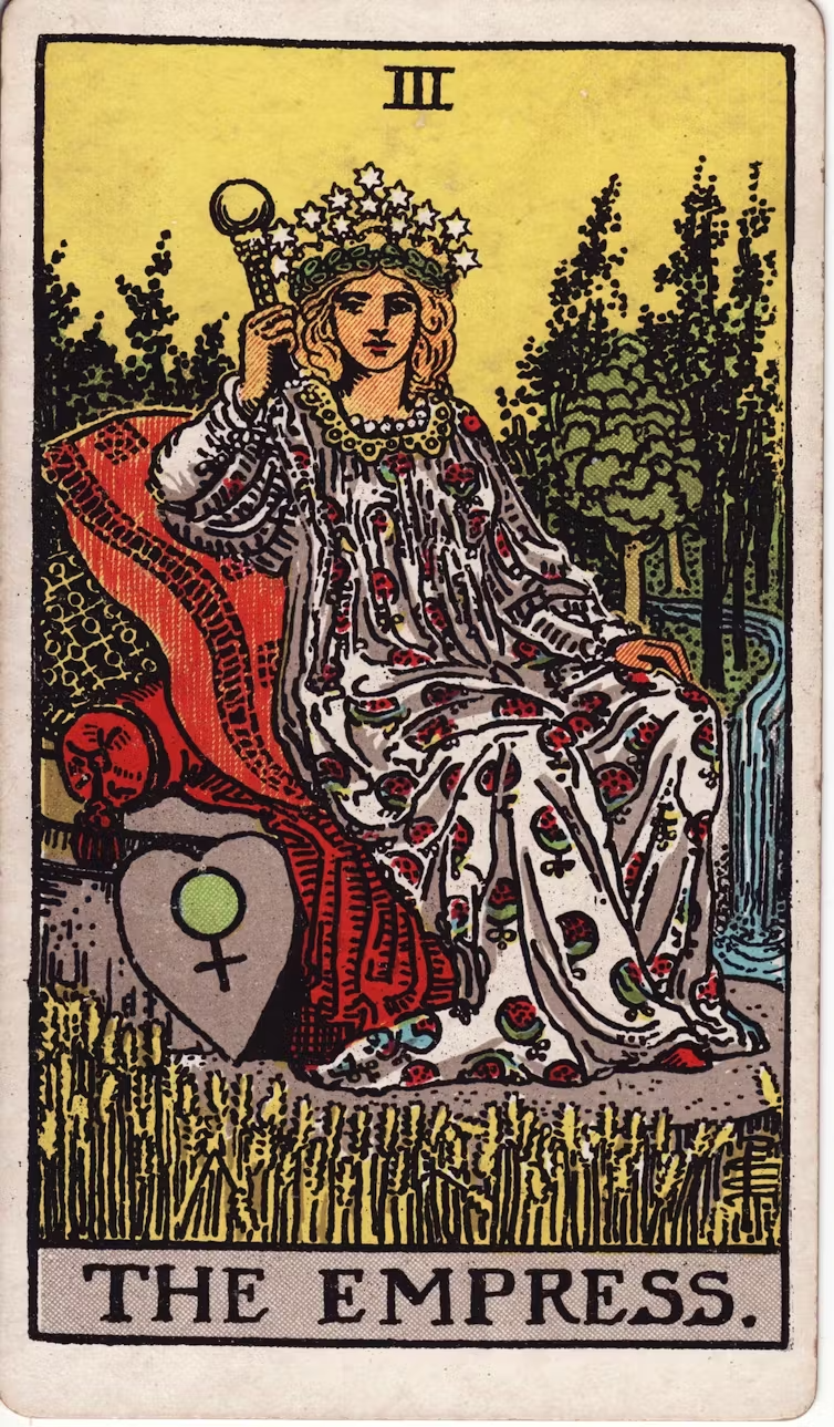 a drawing of a woman in red and white robe. she sits down on a chair.