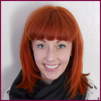 A headshot of a woman with red hair.