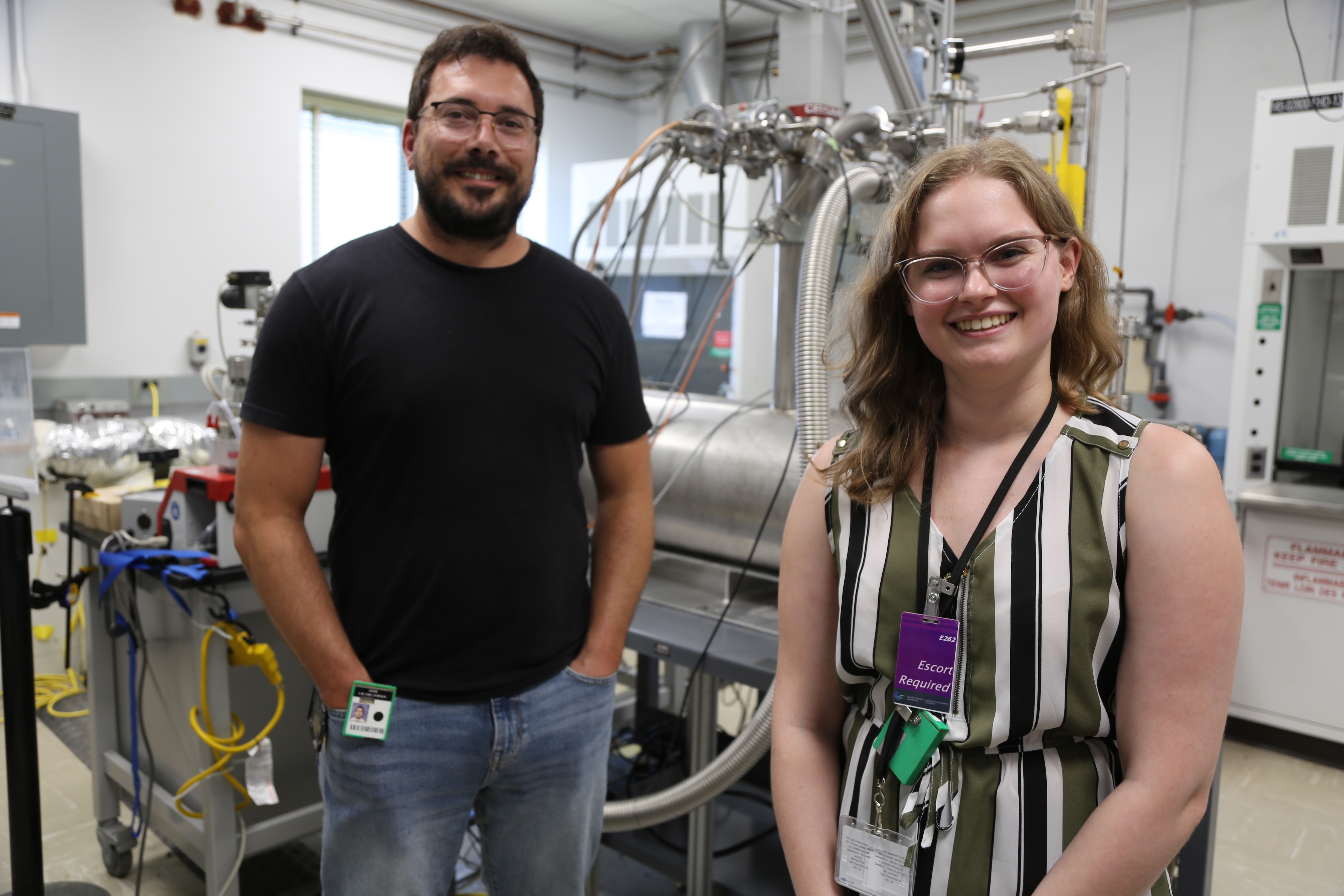 Two people stand in a labratory.
