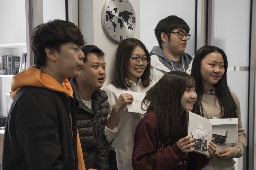 A group of McMaster ESL students hold thank you cards