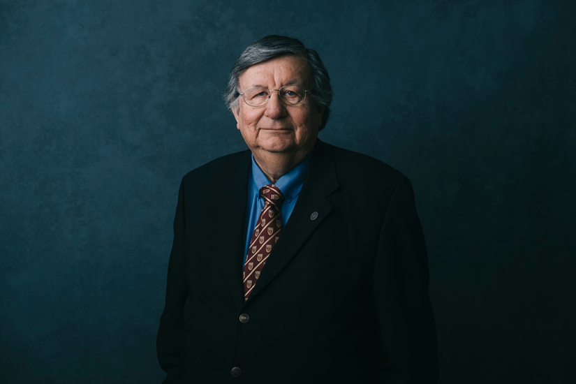 Photo of McMaster Engineering alumnus Barry Hill in black suit and blue shirt.