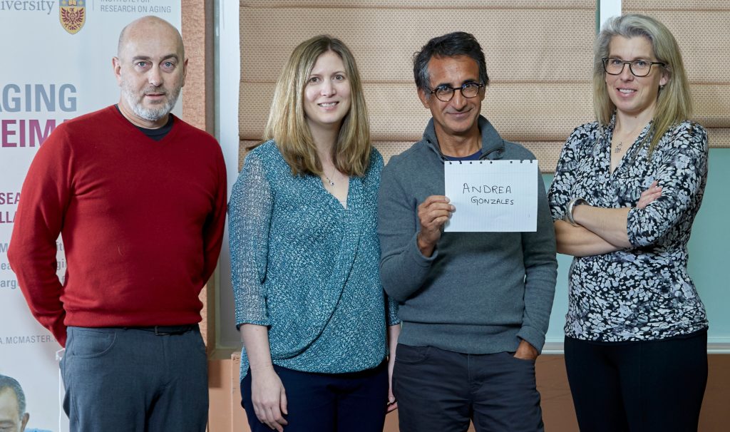 James Gillett, left, Marla Beauchamp, Parminder Raina and Brenda Vrkljan hold up the name of fellow researcher Andrea Gonzales after presenting their Catalyst grant-winning research proposals through the McMaster Institute for Research in Aging.