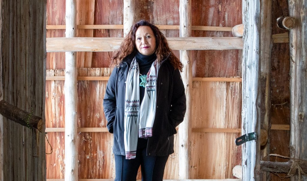 Dawn Martin Hill standing in the doorway of the Kayanese Longhouse on Six Nations