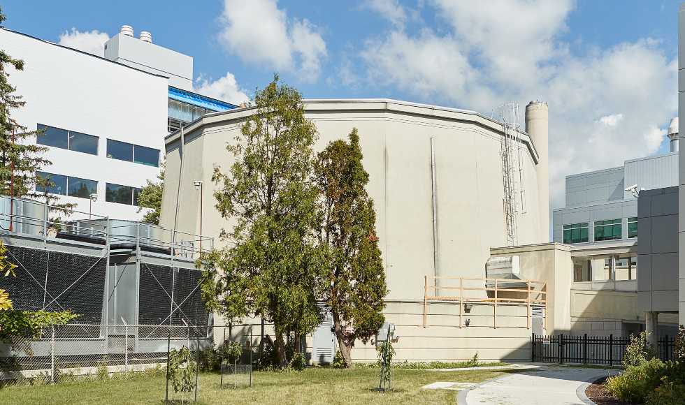 The exterior of a round building on a sunny day in summer