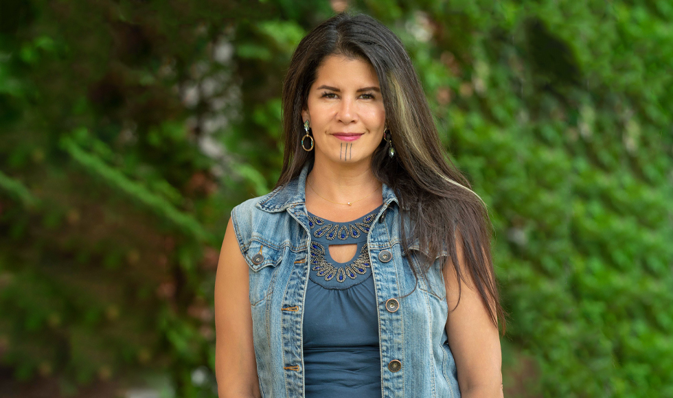 A photo of a woman wearing a jean vest