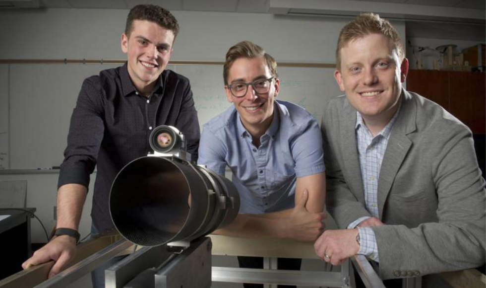 McMaster associate professor Andrew Gadsden and two students posing with ARTEMIS – an autonomous, robotic, telescope mount instrument subsystem