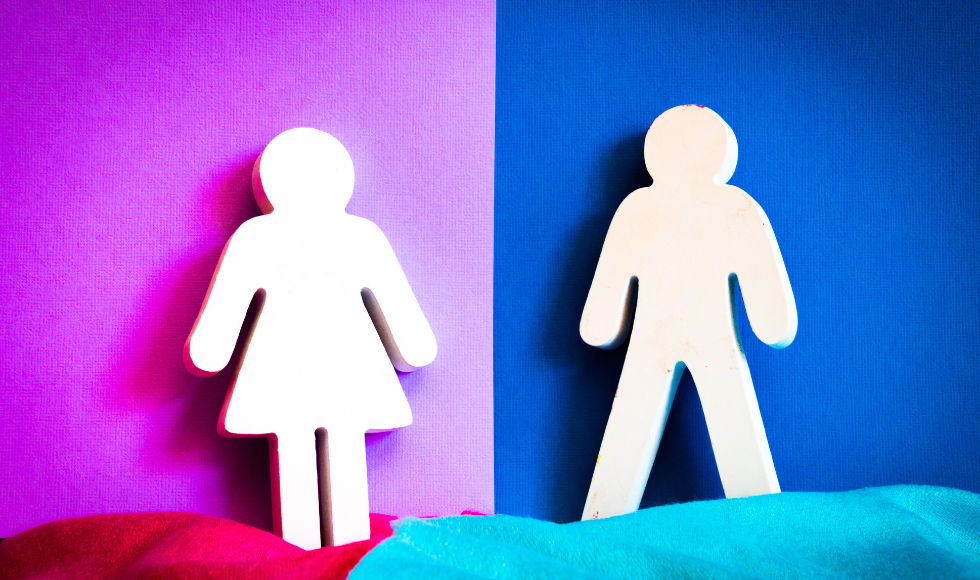 Paper cutouts of two stick figures, one in a dress against a pink backdrop, one with legs against a blue backdrop