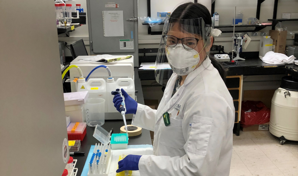 Angela Huynh working in a lab