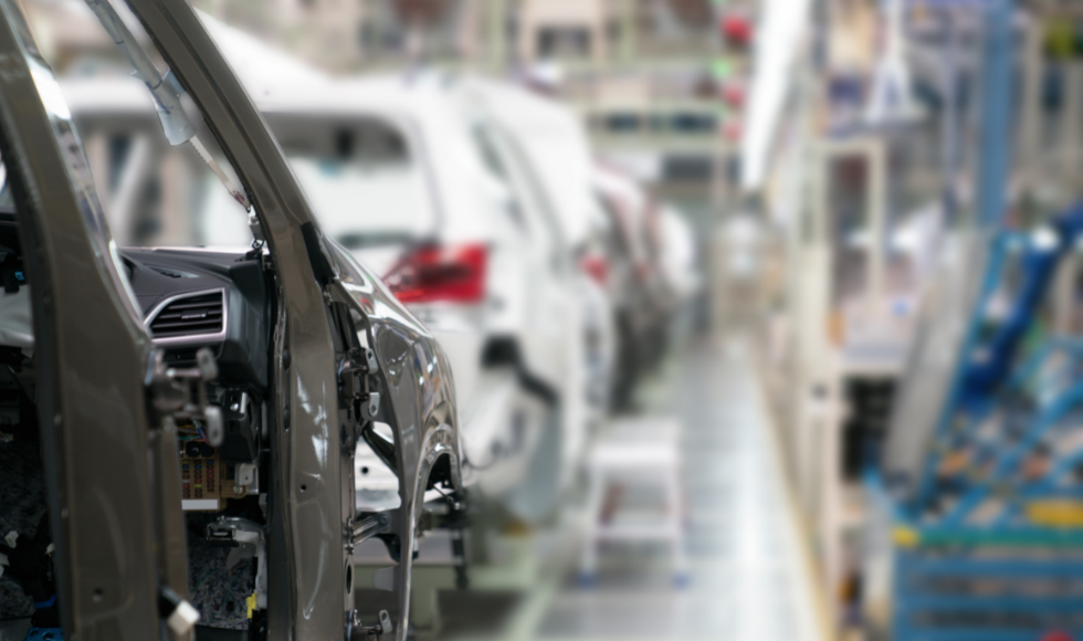 A line of cars on an automotive plant floor