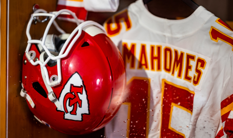 A close-up photo of a red football helmet and jersey