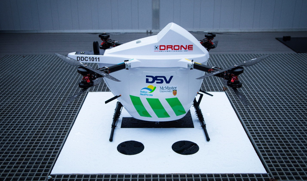 A drone with the logos for McMaster, Halton Healthcare and DSV Canada