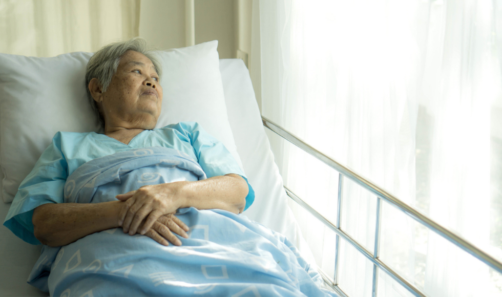Person laying in a hospital bed