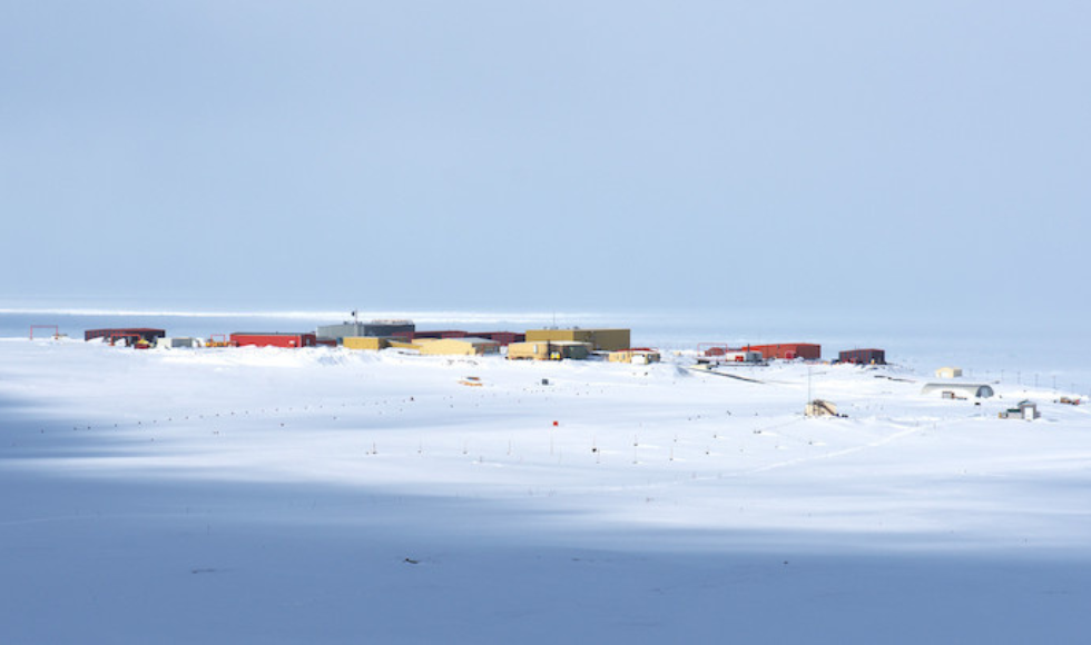 An arctic landscape with buildings surrounded by ice and snow