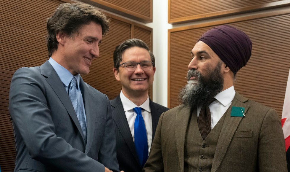Justin Trudeau and Jagmeet Singh shaking hands while Pierre Poilievre looks on