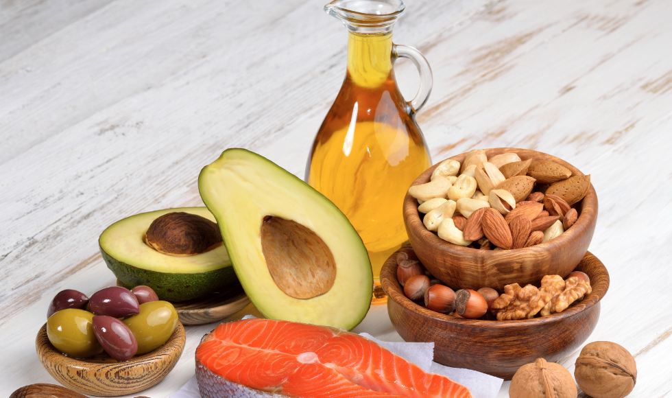 A spread of foods rich in omega-3 fatty acids, including nuts, seeds, salmon and avocado