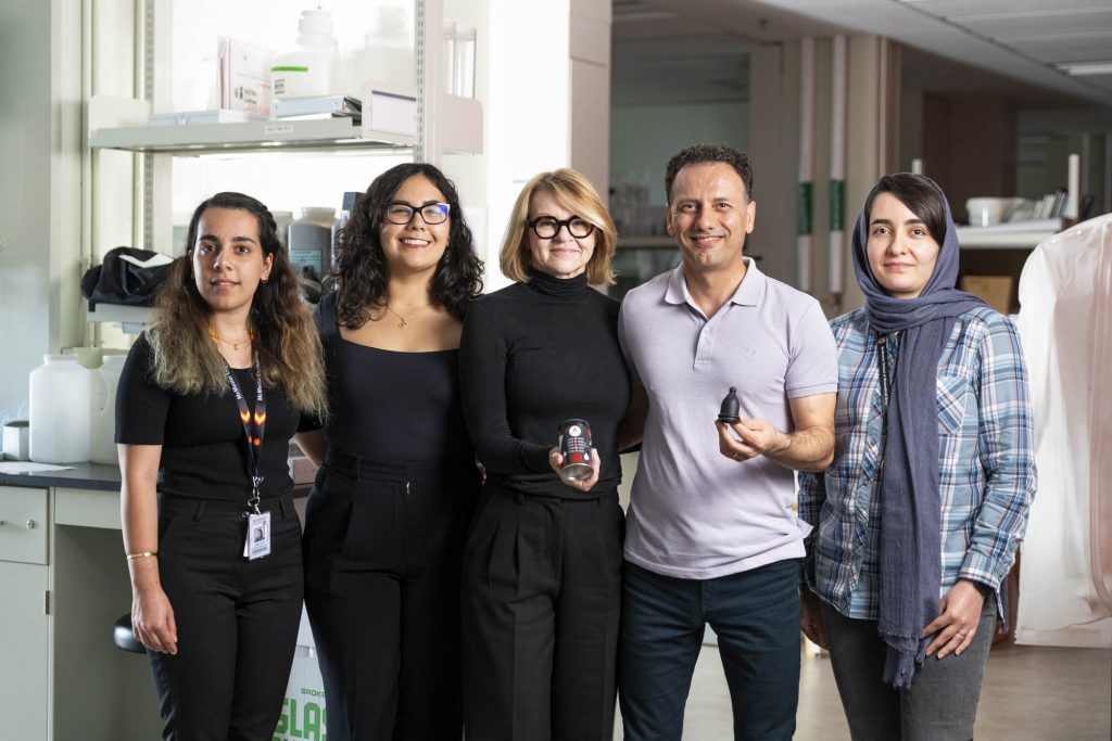 Five individuals standing for a picture