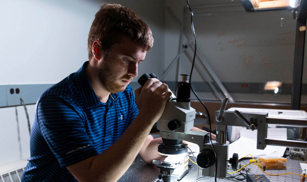 Researcher working in the Engineering Physics optics lab.