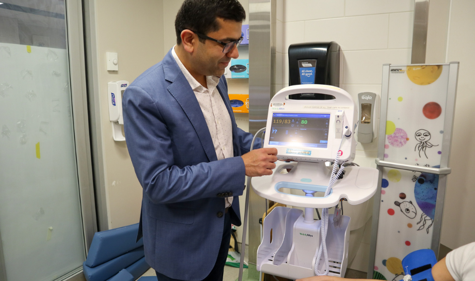 Rahul Chanchlani in a pediatric exam room with a child-size blood pressure monitor