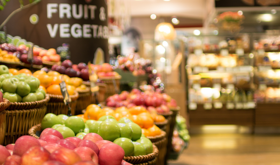 fruit and vegetables on display inside a grocery store