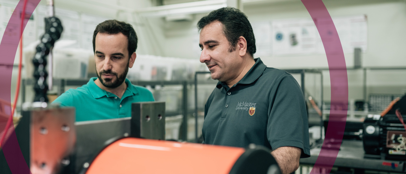 Two engineers study an electric motor together.