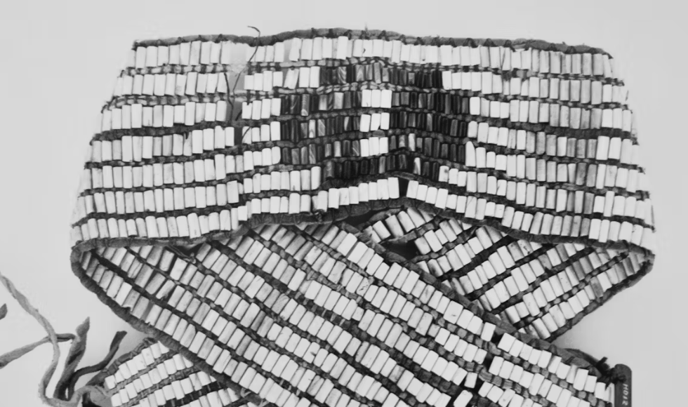 A black-and-white photo of a wampum belt made up of beads