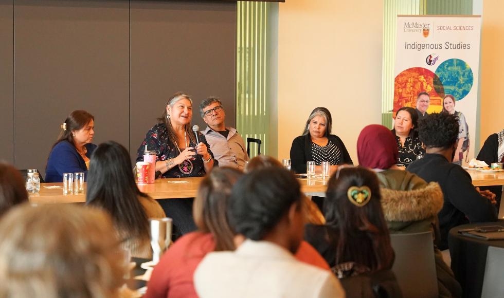 A panel of researchers at a table in front of a banner labelled Indigenous Studies