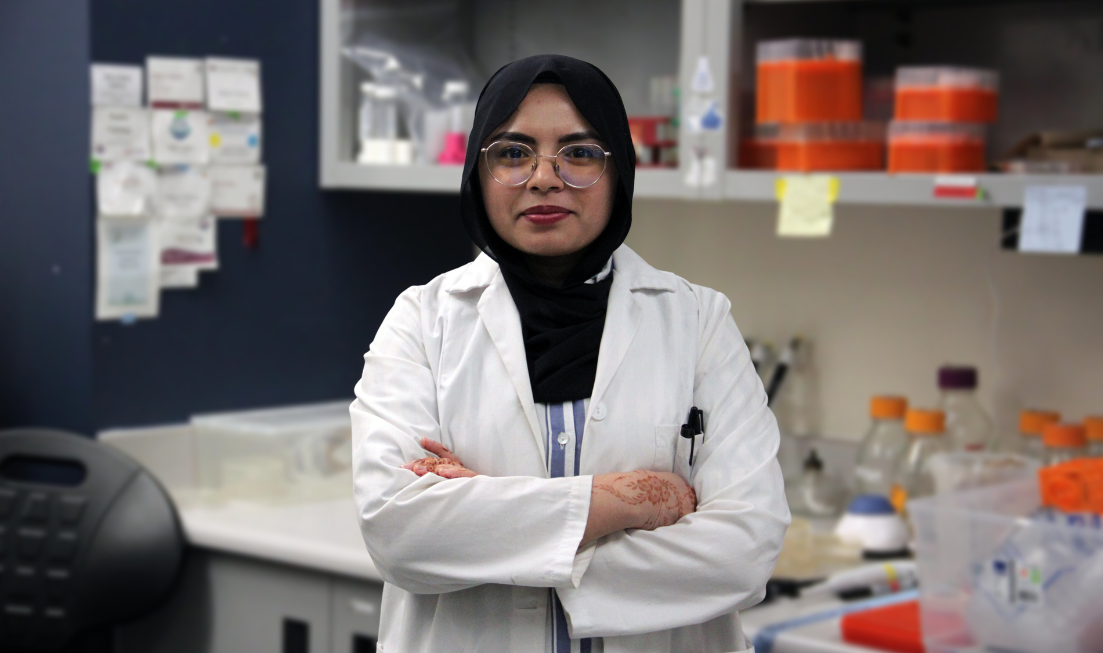 Rabia Fatima, wearing a hijab, a lab coat and a stethescope around her neck