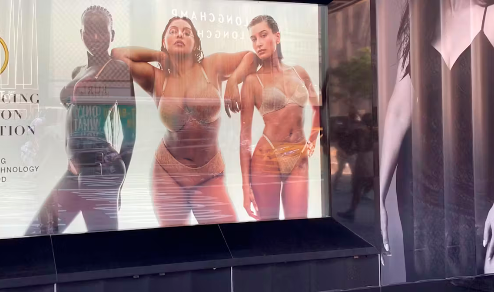 A large ad board of three women in underwear.