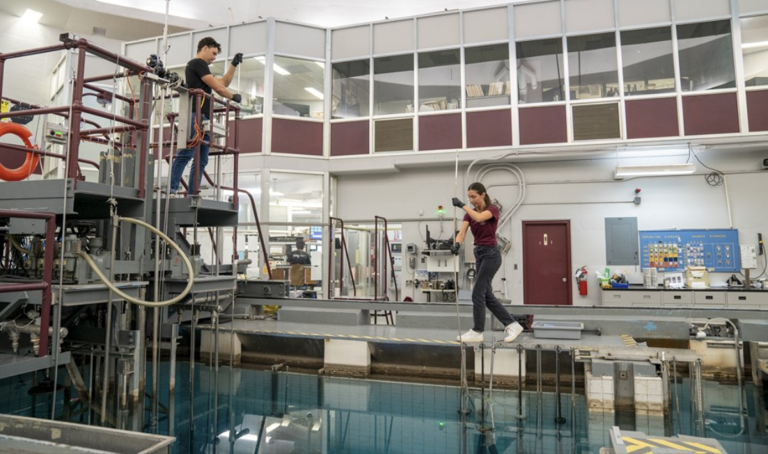 Two people working inside the McMaster Nuclear Reactor