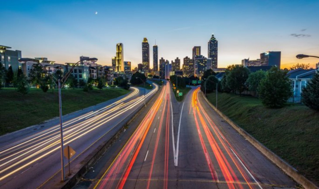 slow exposure aerial image of a city's highways in the evening.