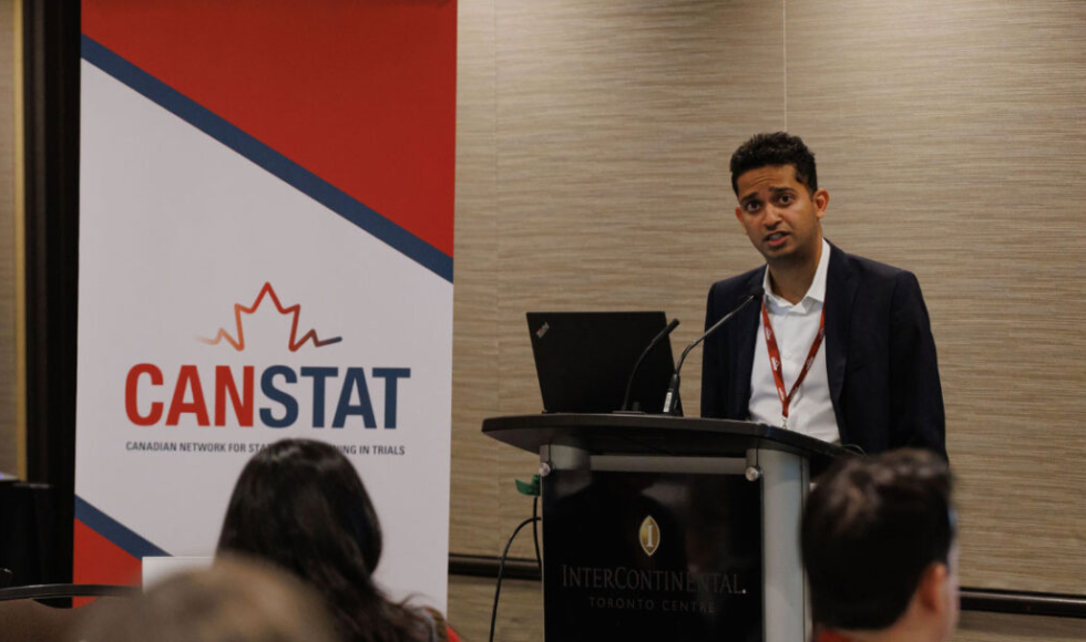 A man stands at a podium in front of an audience.